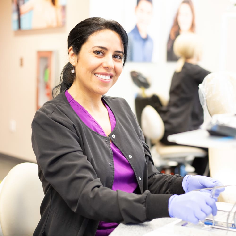 Two team members at Nalchajian Orthodontics look at a clip board.