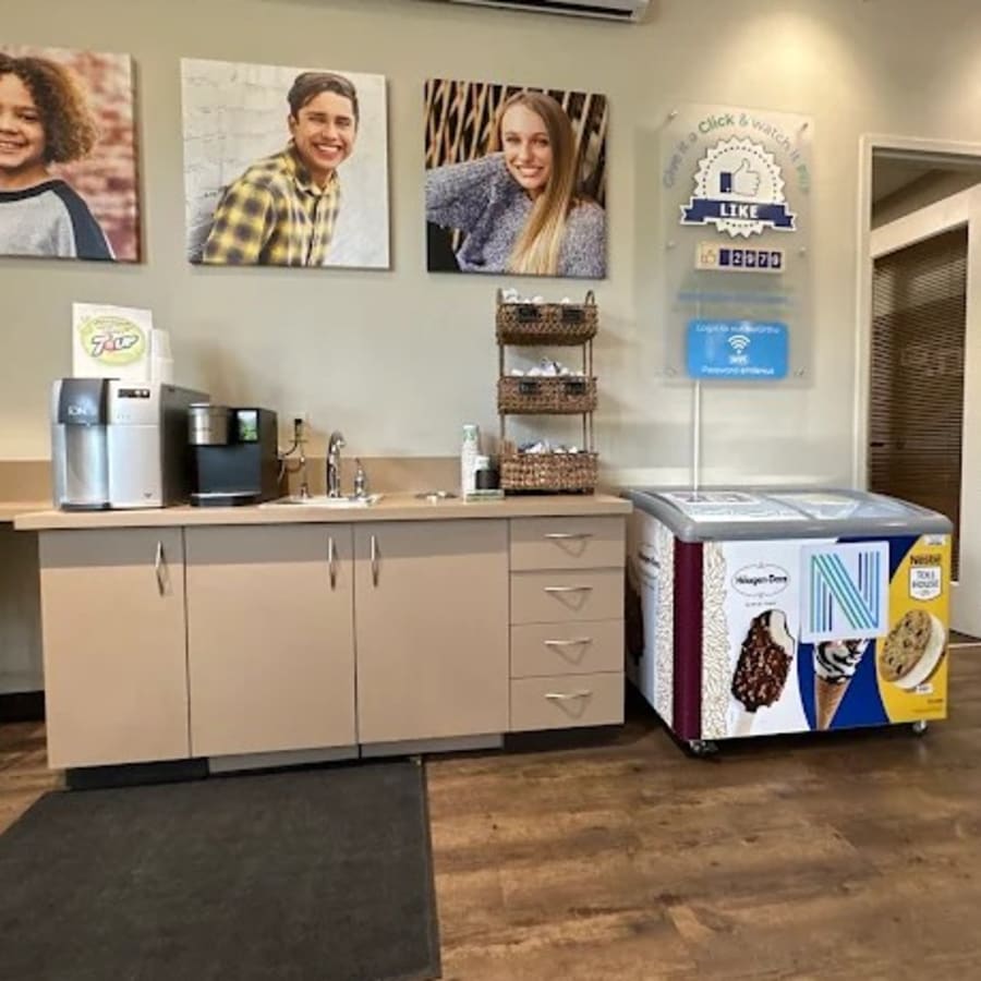 A patient is greeted at the Nalchajian Orthodontics front desk.