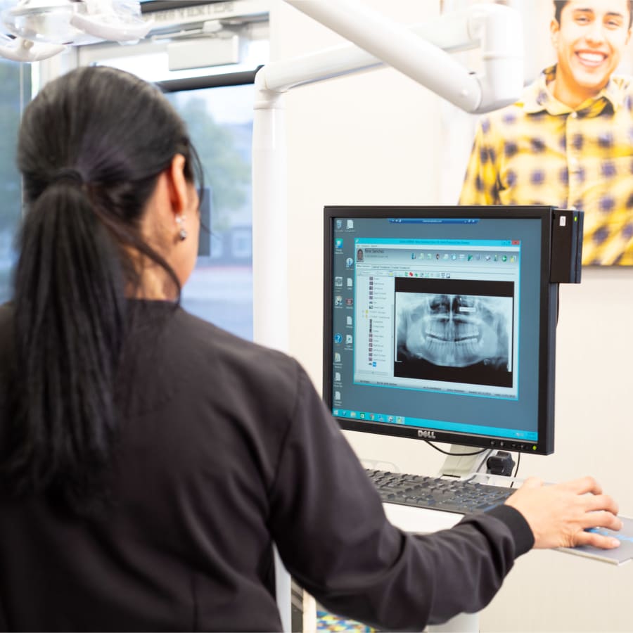 A team member at Nalchajian Orthodontics reviews a dental X-ray.