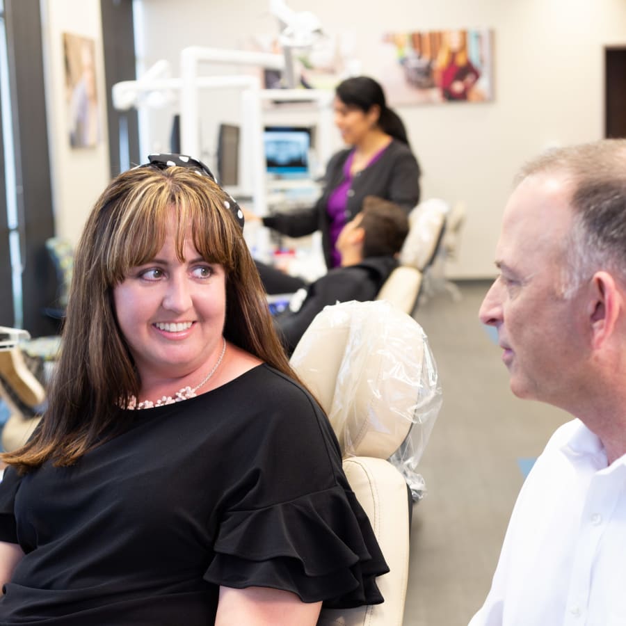 A patient speaks with a team member at Nalchajian Orthodontics.
