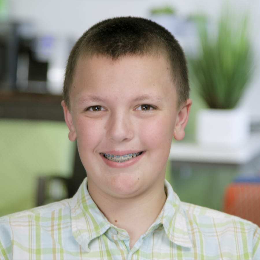 Two team members at Nalchajian Orthodontics review a document on a clipboard.