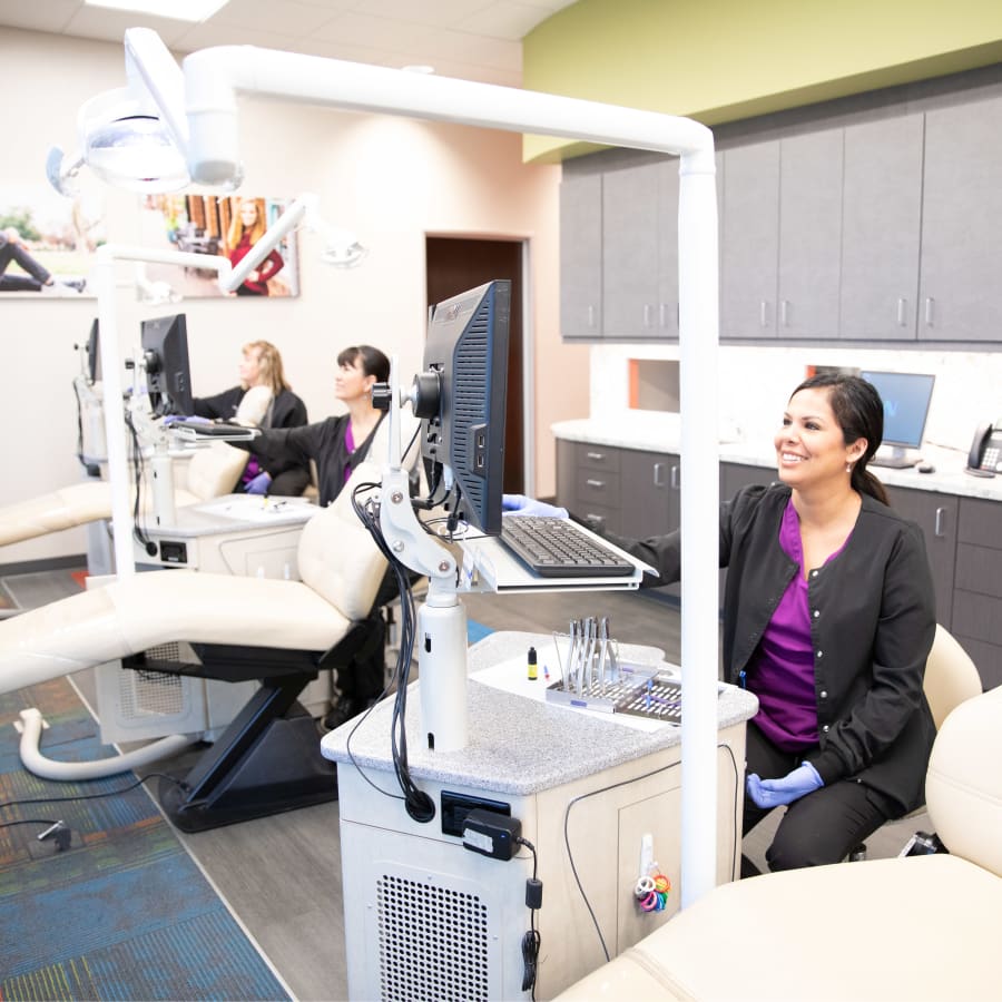 Team members at Nalchajian Orthodontics prepare their work stations for patients.