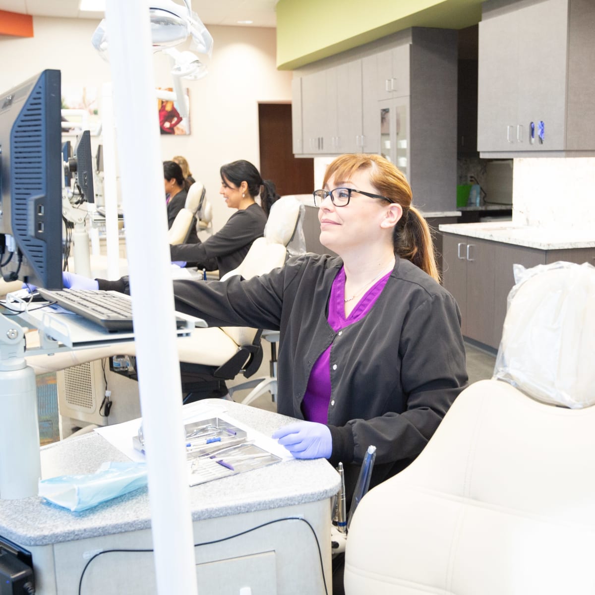 Team members at Nalchajian Orthodontics prepare their workstations for patients.